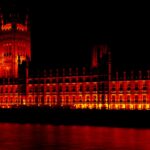 Houses of parliament at night. A red filter gives a more demonic look to contrast the myth that the government works for you